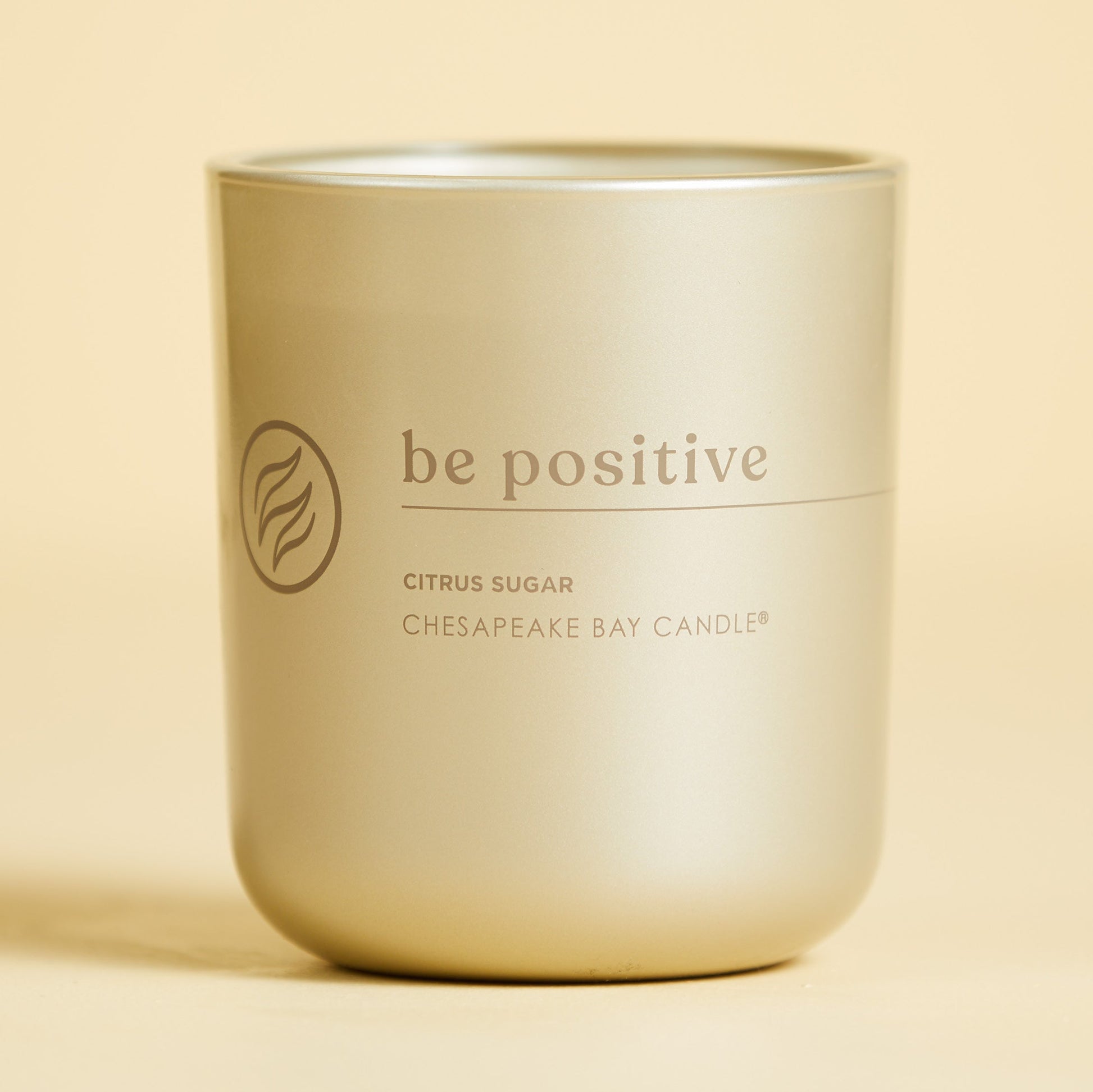 chesapeake bay candle intentions collection be positive citrus sugar medium two wick candle in a pastel yellow backdrop